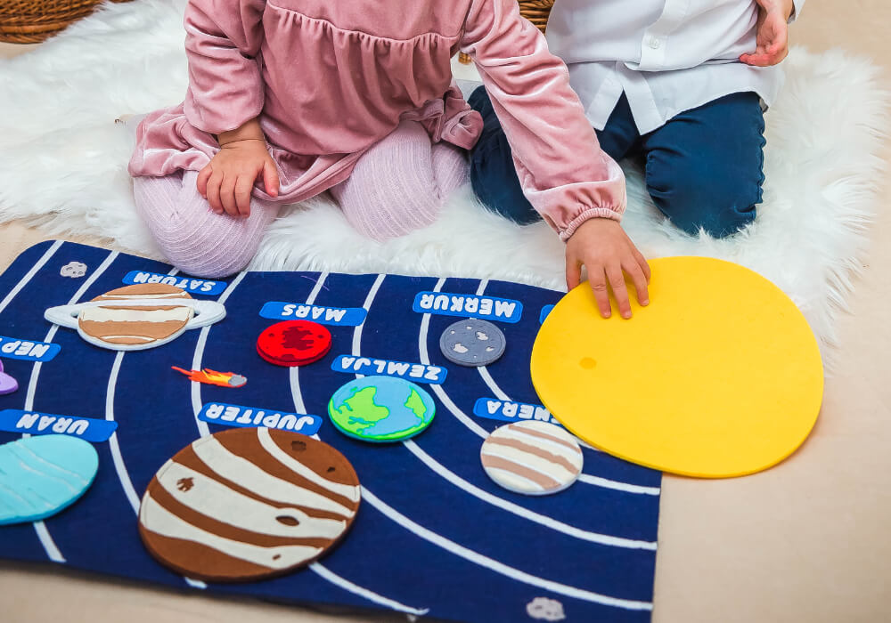 Kids Learning with Solar System Toys Children engaged in learning about the solar system with interactive educational toys.
