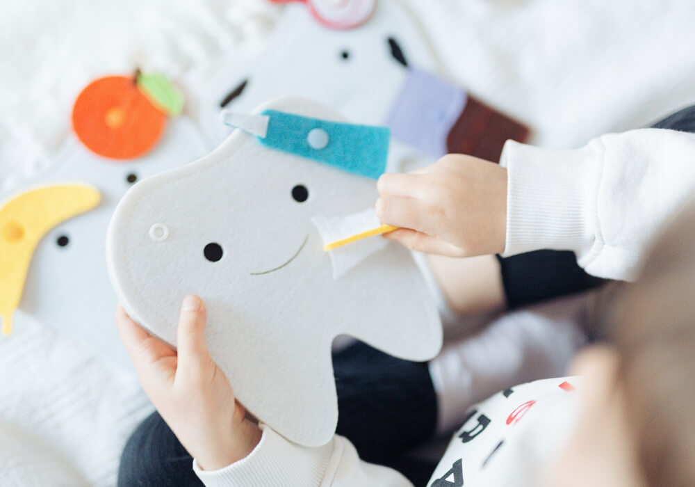 Kids Learning Oral Hygiene with Interactive Tooth Toy Kids engaging with the tooth toy while learning about oral hygiene and dental health in an interactive setting